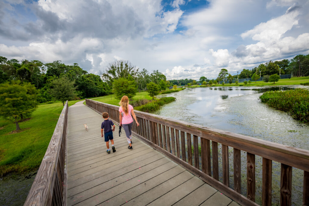 People walking over Lake Lawne at Barnett Park