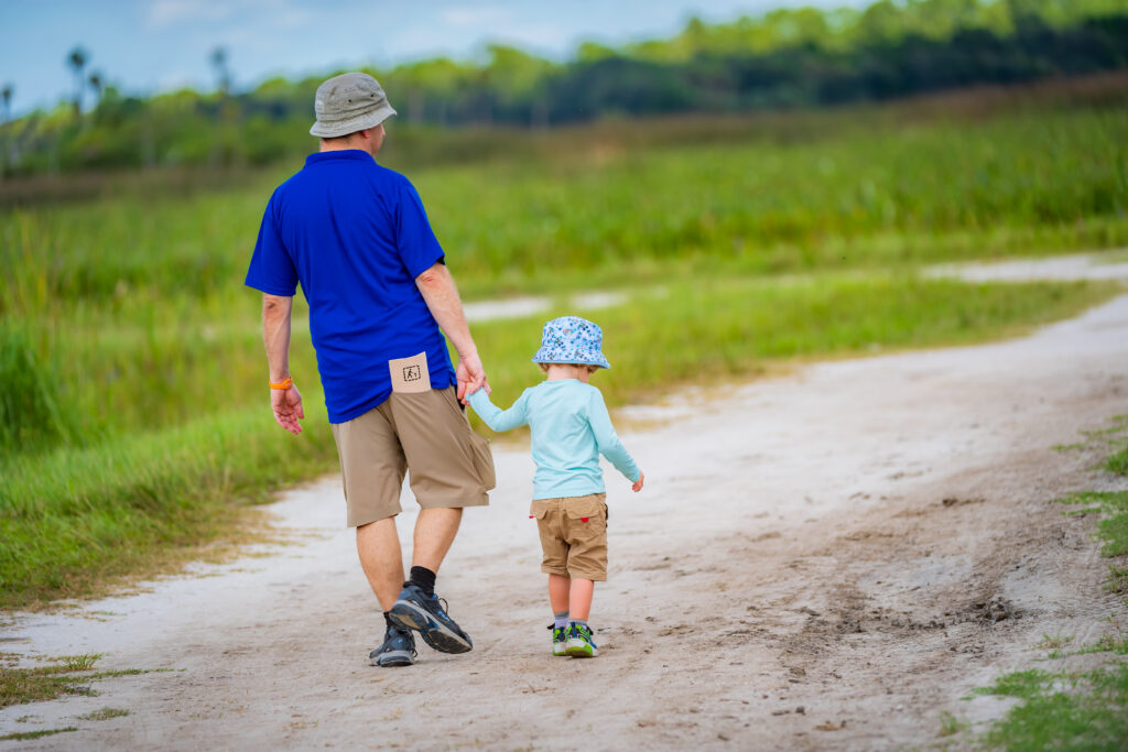 Parent and child walking in Orlando Wetlands Park