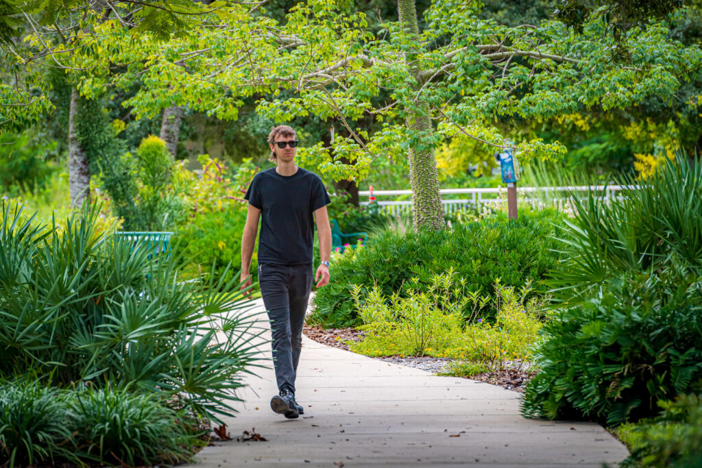 Person walking in Ridgewood Park Butterfly Garden